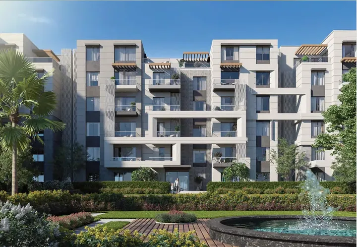 عمارات سكنية ونافورة وسط الحدائق في بادية