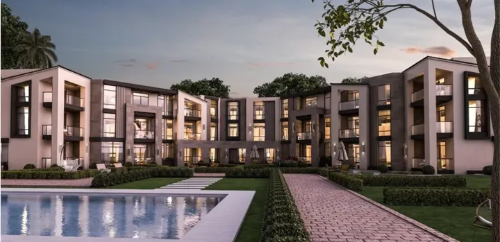 Attached homes around a pool and a paved walkway in Keeva