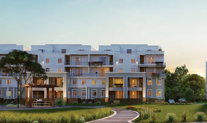عمارات سكنية ومظلة خشبية وحديقة في أكتوبر بلازا