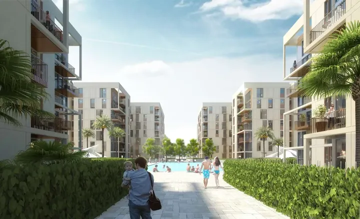 Walkway between apartment buildings leading to a pool in Odyssia